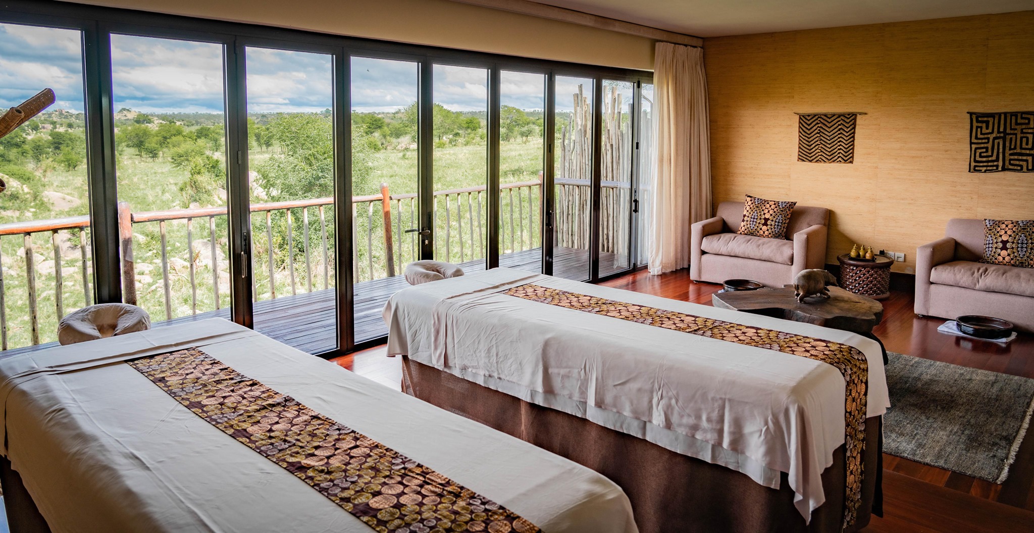 "A luxurious safari lodge in East Africa overlooking the savannah, with an open-air spa and infinity pool.