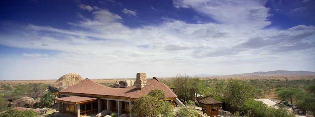 a Lodge with a chimney in the middle of a field